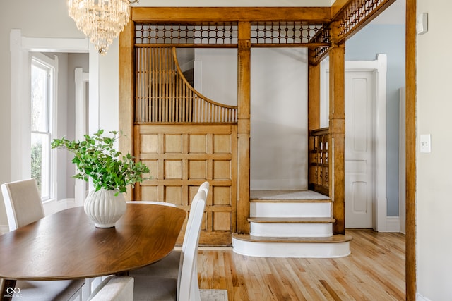 unfurnished dining area featuring light wood-type flooring and a chandelier