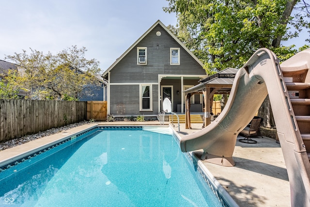 1715 Alabama St, Indianapolis, IN 46202 - back of property featuring a fenced backyard, a gazebo, a patio, and a fenced in pool
