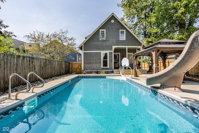 1715 Alabama St, Indianapolis, IN 46202 - view of swimming pool featuring a gazebo, a fenced backyard, a patio, a fenced in pool, and a water slide