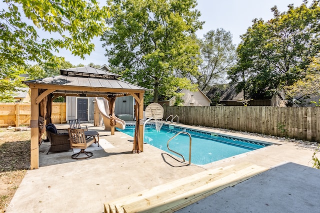 view of pool with a water slide, a patio, and a gazebo