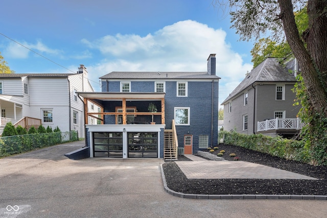 rear view of property featuring a sunroom