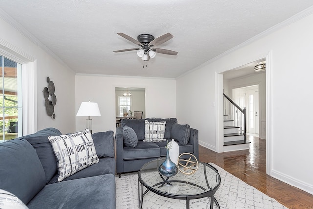 living room with ceiling fan, a textured ceiling, ornamental molding, and dark hardwood / wood-style flooring