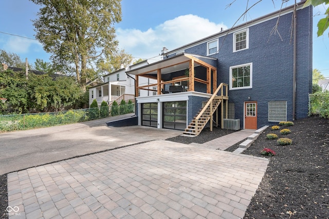 rear view of house featuring a patio area and central AC unit