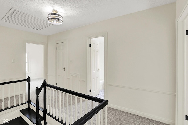 22 W 54th St, Indianapolis, IN 46208 - staircase featuring carpet floors and a textured ceiling
