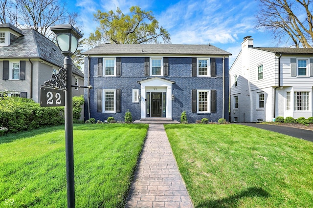 22 W 54th St, Indianapolis, IN 46208 - colonial house featuring a front lawn and brick siding