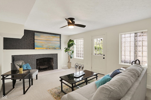 22 W 54th St, Indianapolis, IN 46208 - carpeted living room with a textured ceiling, ceiling fan, baseboards, and a brick fireplace