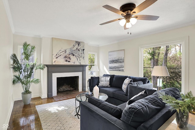 22 W 54th St, Indianapolis, IN 46208 - living room with crown molding, ceiling fan, a tiled fireplace, and baseboards