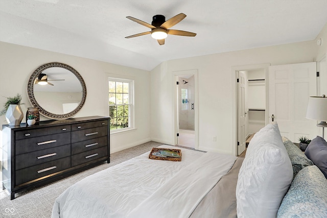 22 W 54th St, Indianapolis, IN 46208 - bedroom with a ceiling fan, a walk in closet, baseboards, light colored carpet, and lofted ceiling