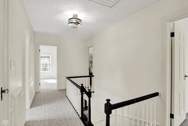 22 W 54th St, Indianapolis, IN 46208 - hallway featuring an upstairs landing, a textured ceiling, and carpet