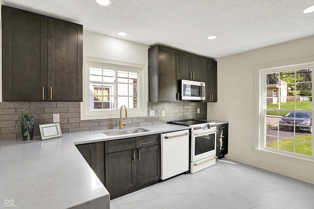 22 W 54th St, Indianapolis, IN 46208 - kitchen featuring white appliances, plenty of natural light, marble finish floor, and a sink