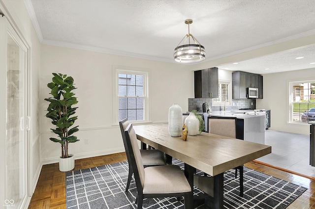 22 W 54th St, Indianapolis, IN 46208 - dining area featuring baseboards, ornamental molding, and a textured ceiling