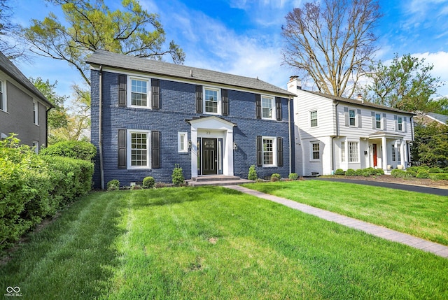 22 W 54th St, Indianapolis, IN 46208 - view of front facade with brick siding and a front lawn