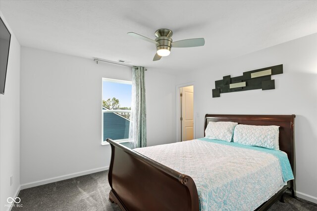 bedroom featuring dark colored carpet and ceiling fan