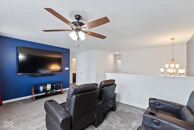 home theater with ceiling fan with notable chandelier and carpet