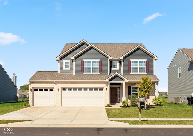 craftsman house featuring a front yard and a garage