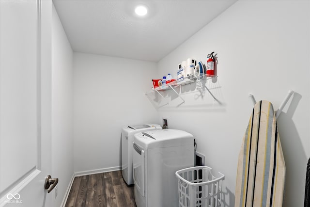 clothes washing area featuring washer and dryer and dark hardwood / wood-style flooring