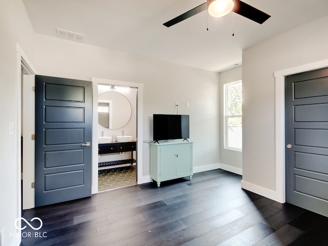 unfurnished bedroom featuring dark wood-type flooring, ceiling fan, and ensuite bathroom