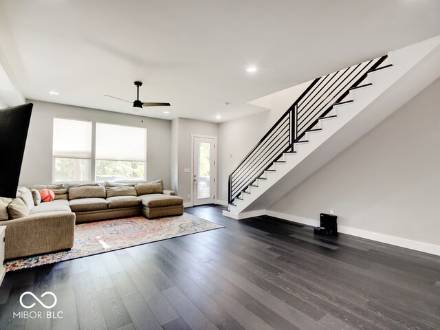 unfurnished living room featuring ceiling fan and dark hardwood / wood-style floors