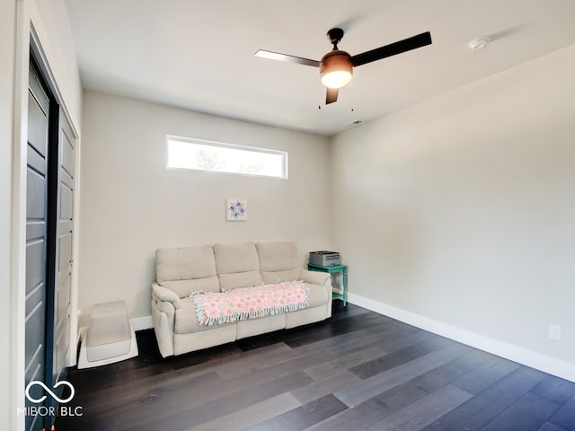 sitting room with dark wood-type flooring and ceiling fan