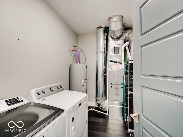 laundry area with dark wood-type flooring, washer and clothes dryer, and water heater