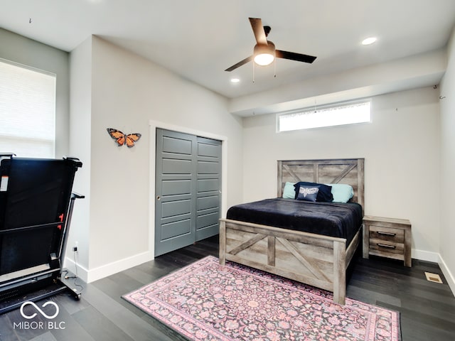 bedroom featuring a closet, ceiling fan, and dark hardwood / wood-style floors