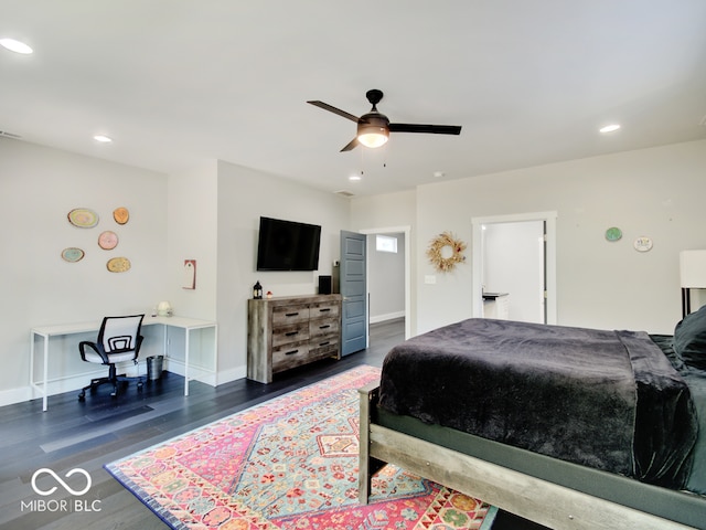 bedroom with ceiling fan and dark hardwood / wood-style floors