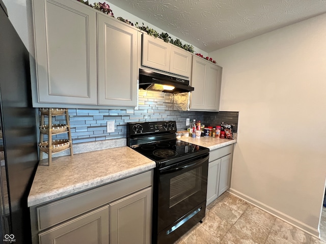 kitchen with black appliances, a textured ceiling, and backsplash