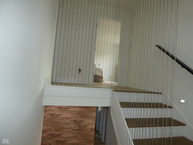 staircase featuring wood-type flooring