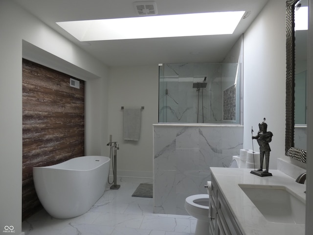 full bathroom featuring a skylight, independent shower and bath, toilet, and vanity