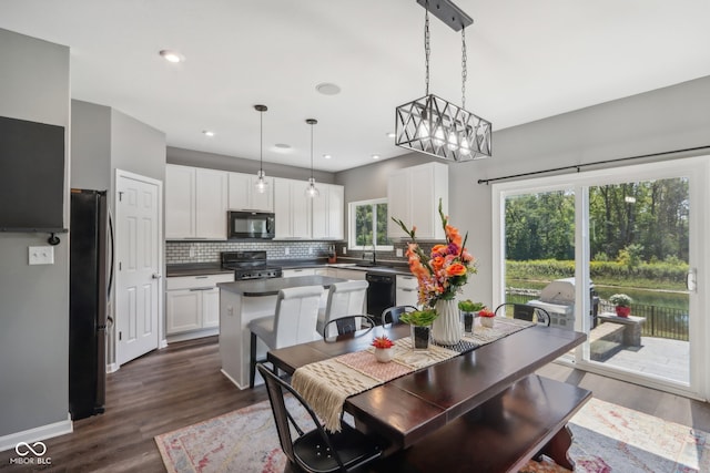 dining space with dark hardwood / wood-style floors and sink