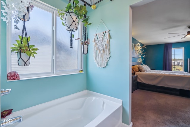 bathroom with ceiling fan and a bathtub