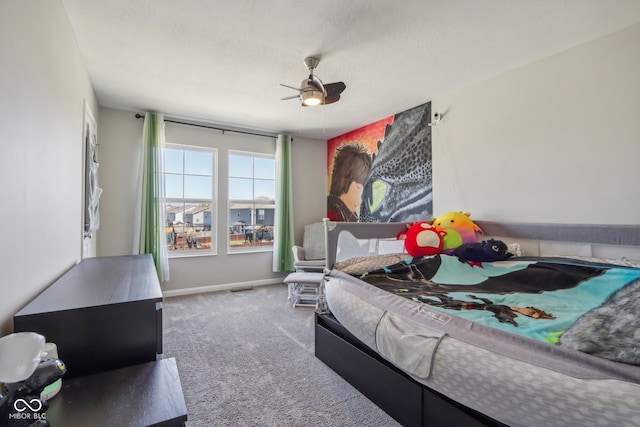 carpeted bedroom featuring a textured ceiling and ceiling fan