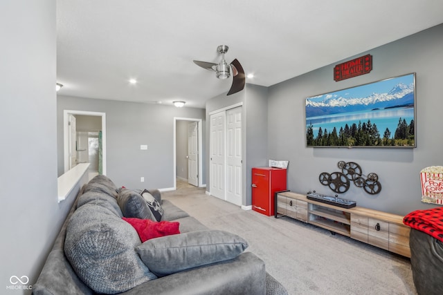 living room with ceiling fan and light colored carpet