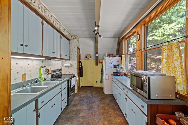 kitchen featuring stainless steel appliances, white cabinetry, and sink