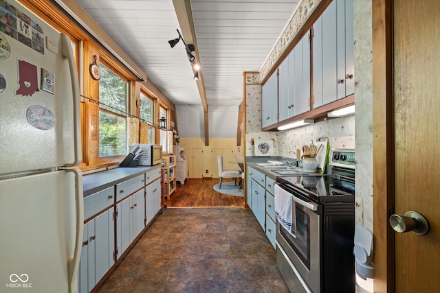 kitchen featuring white cabinetry, stainless steel electric range oven, white fridge, rail lighting, and dark hardwood / wood-style flooring