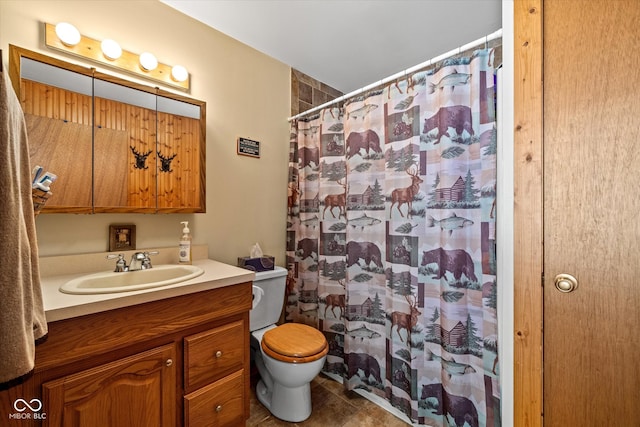 bathroom featuring tile patterned flooring, curtained shower, vanity, and toilet