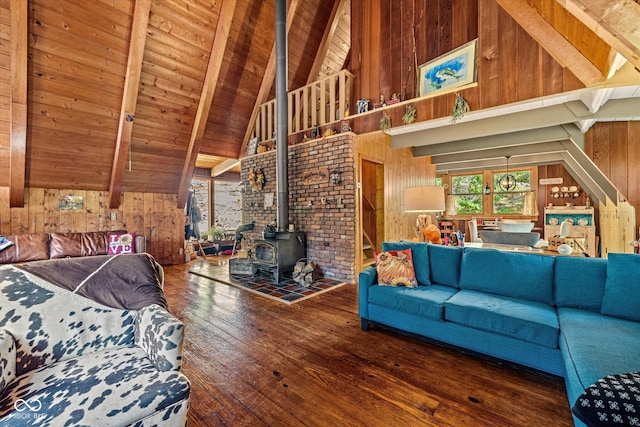 living room with wood-type flooring, beamed ceiling, a wood stove, high vaulted ceiling, and wooden walls