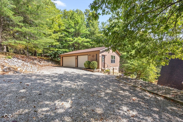 view of front of property featuring an outdoor structure and a garage