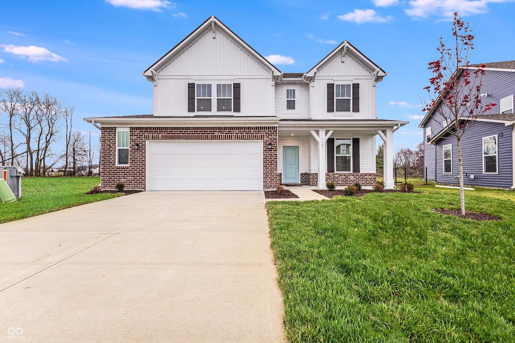 view of front of house featuring a garage and a front lawn