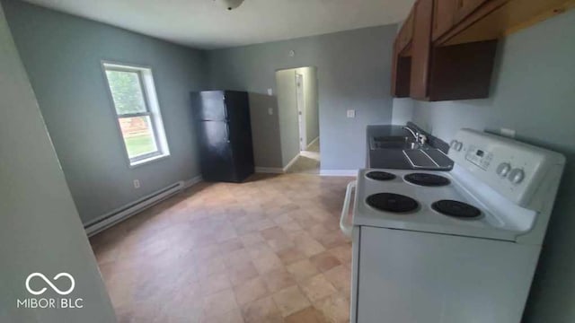 kitchen featuring a baseboard heating unit, sink, black refrigerator, and white range with electric cooktop