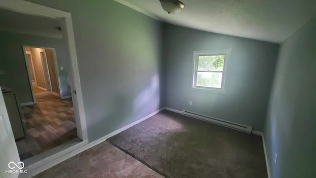 unfurnished room featuring dark carpet, a baseboard radiator, and vaulted ceiling