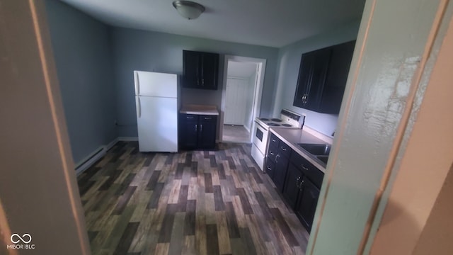 kitchen with dark wood-type flooring, white appliances, baseboard heating, and sink