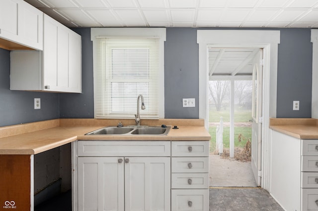 kitchen featuring sink, white cabinetry, and a healthy amount of sunlight