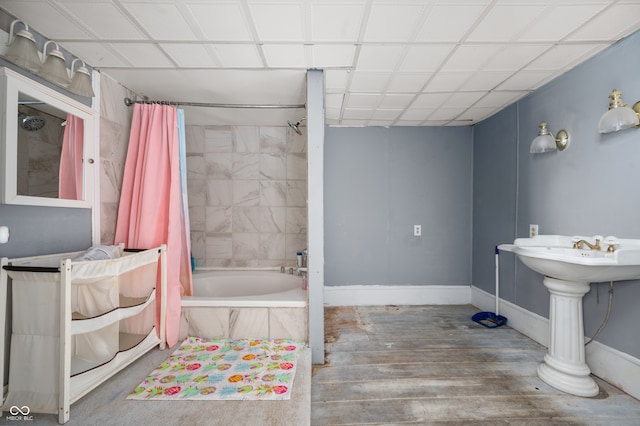 bathroom with shower / bath combo and hardwood / wood-style floors