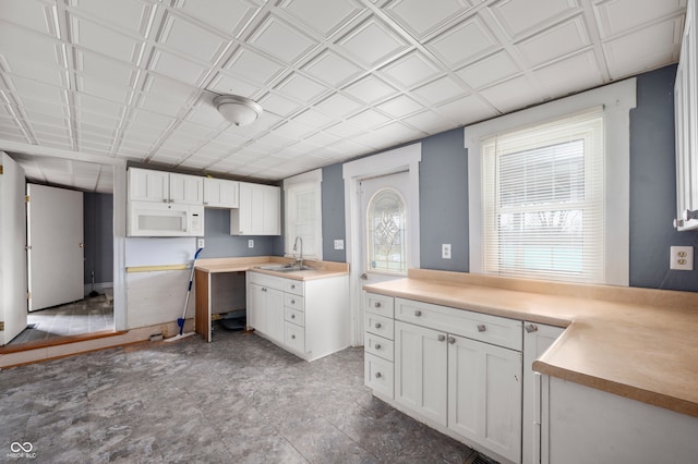 kitchen with white cabinetry and sink