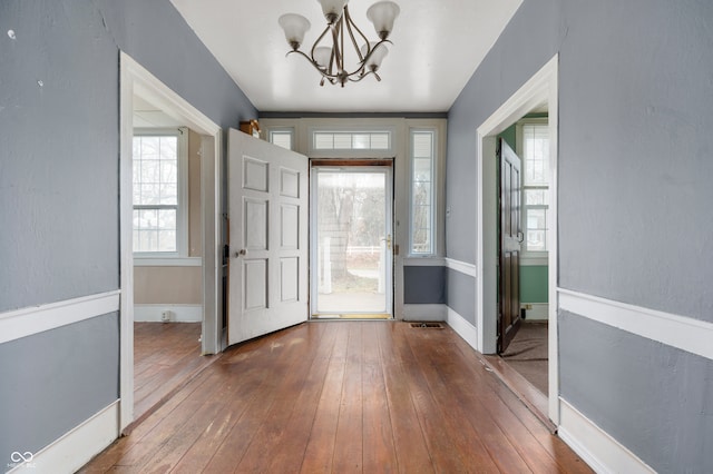 entryway with a chandelier and hardwood / wood-style flooring