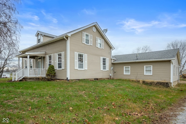 back of property featuring a porch and a lawn