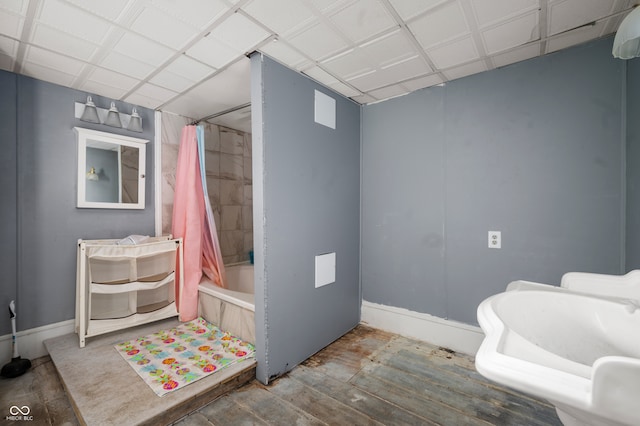 bathroom featuring shower / tub combo with curtain and hardwood / wood-style flooring