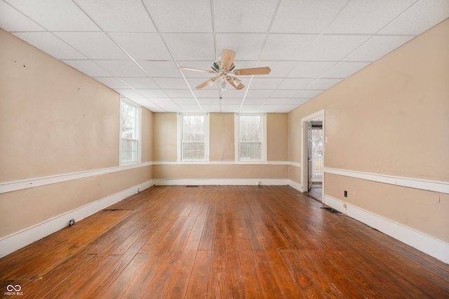 unfurnished room featuring a paneled ceiling, ceiling fan, and hardwood / wood-style flooring