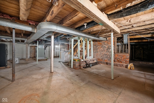 basement with washer / clothes dryer and heating unit